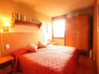 a bedroom with a bed with a red blanket and a window at Chalet 5 ch, 11 pers, terrasse sud, Les Carroz - FR-1-572-115 in Arâches-la-Frasse