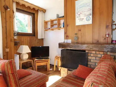 a living room with a couch and a fireplace at Duplex 8 pers avec parking, pied des pistes, proche commodités - FR-1-572-127 in Arâches-la-Frasse