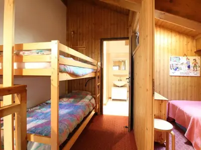 a bedroom with two bunk beds in a cabin at Duplex 8 pers avec parking, pied des pistes, proche commodités - FR-1-572-127 in Arâches-la-Frasse