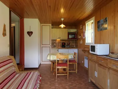 a kitchen with a table and a small kitchen with a tableablish at 2 pièces, 4 pers, terrasse, rez-de-jardin, face aux pistes, proche centre, équipements inclus - FR-1-572-160 in Arâches-la-Frasse