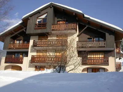 a building with balconies and snow in front of it at 2 pièces, 4 pers, terrasse, rez-de-jardin, face aux pistes, proche centre, équipements inclus - FR-1-572-160 in Arâches-la-Frasse