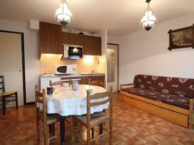 a living room with a table and a couch at Studio spacieux 4 pers, lit double, pistes, parking - FR-1-572-146 in Arâches-la-Frasse