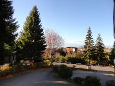 a street with trees and a bench on the side of a road at Studio spacieux 4 pers, lit double, pistes, parking - FR-1-572-146 in Arâches-la-Frasse
