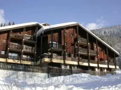 a large building in the snow with snow at Appartement cosy 2 pièces, terrasse, pour 6 personnes au pied des pistes et proche du centre - FR-1-572-125 in Arâches-la-Frasse