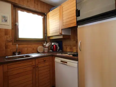a small kitchen with a sink and a refrigerator at Appartement cosy 2 pièces, terrasse, pour 6 personnes au pied des pistes et proche du centre - FR-1-572-125 in Arâches-la-Frasse