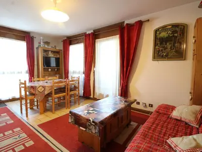 a living room with a table and a dining room at Charmant 2P avec balcon, 5 couchages, pieds des pistes, proche télécabine et centre village - FR-1-572-171 in Arâches-la-Frasse