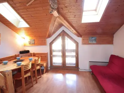 a living room with a table and a couch at Studio mezzanine 5 pers, pied des commerces, 450m des pistes - FR-1-572-184 in Arâches-la-Frasse