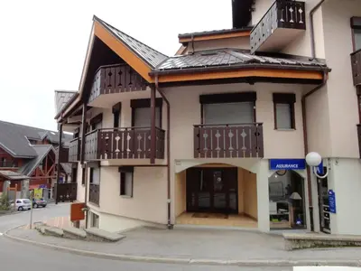 a building with balconies on the side of a street at Studio mezzanine 5 pers, pied des commerces, 450m des pistes - FR-1-572-184 in Arâches-la-Frasse