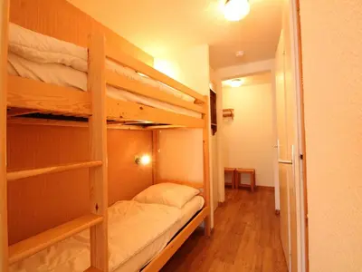 a room with two bunk beds in a room at Studio rénové 4 pers, centre village, proche pistes et commerces - FR-1-572-61 in Arâches-la-Frasse