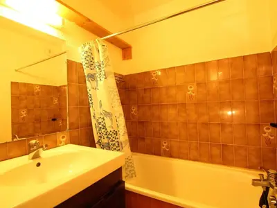a bathroom with a sink and a tub and a shower at Studio rénové 4 pers, centre village, proche pistes et commerces - FR-1-572-61 in Arâches-la-Frasse