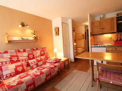 a living room with a couch and a table and a kitchen at Studio rénové 4 pers, centre village, proche pistes et commerces - FR-1-572-61 in Arâches-la-Frasse
