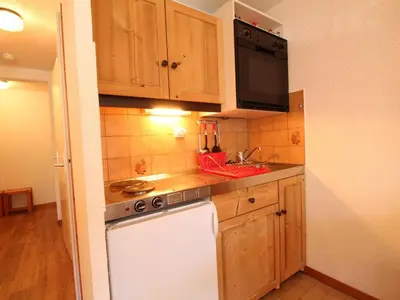 a small kitchen with a stove and a microwave at Studio rénové 4 pers, centre village, proche pistes et commerces - FR-1-572-61 in Arâches-la-Frasse