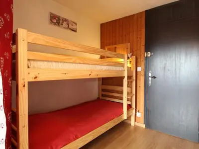 a bedroom with two bunk beds in a room at Studio 4 pers. proche pistes et commerces, balcon, parking - FR-1-572-131 in Arâches-la-Frasse