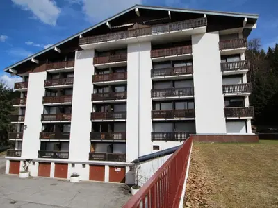 an apartment building with balconies and a fence at Studio 4 pers. proche pistes et commerces, balcon, parking - FR-1-572-131 in Arâches-la-Frasse