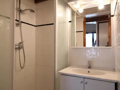 a bathroom with a sink and a shower with a mirror at Charmant appartement 4-6 pers, balcon, proche pistes et commodités - FR-1-572-142 in Arâches-la-Frasse