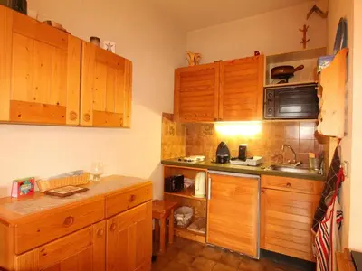 a kitchen with wooden cabinets and a sink at Studio 4 pers au pied des pistes, balcon, casier à skis, TV - FR-1-572-178 in Arâches-la-Frasse