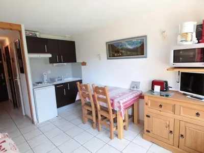 a small kitchen with a table and chairs in it at Studio charmant 4 pers, centre village, proche pistes et commerces - FR-1-572-122 in Arâches-la-Frasse