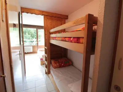 a couple of bunk beds in a room at Studio charmant 4 pers, centre village, proche pistes et commerces - FR-1-572-122 in Arâches-la-Frasse