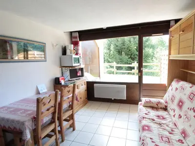 a room with a kitchen with a table and a window at Studio charmant 4 pers, centre village, proche pistes et commerces - FR-1-572-122 in Arâches-la-Frasse