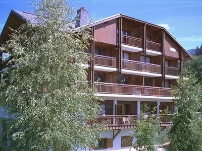 a large apartment building with trees in front of it at Studio charmant 4 pers, centre village, proche pistes et commerces - FR-1-572-122 in Arâches-la-Frasse
