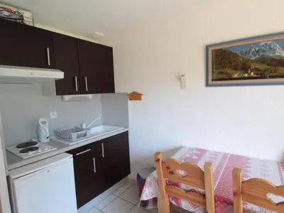 a small kitchen with a sink and a table at Studio charmant 4 pers, centre village, proche pistes et commerces - FR-1-572-122 in Arâches-la-Frasse