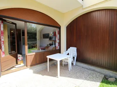 a porch with a table and chairs on a house at Studio charmant 4 pers, centre village, proche pistes et commerces - FR-1-572-122 in Arâches-la-Frasse