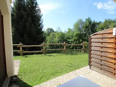 a wooden fence in front of a grass field at Studio charmant 4 pers, centre village, proche pistes et commerces - FR-1-572-122 in Arâches-la-Frasse