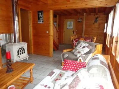 a living room with a couch and a stove at Chalet 3 Chambres 8 Pers, 800m Pistes, Parking Couvert, Poêle à Bois, Quartier Calme - FR-1-572-224 in Arâches-la-Frasse