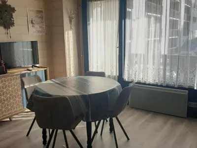 a dining room with a table and chairs and windows at Studio chaleureux, balcon sud, 4 pers., proche centre et pistes - Les Carroz - FR-1-572-218 in Arâches-la-Frasse