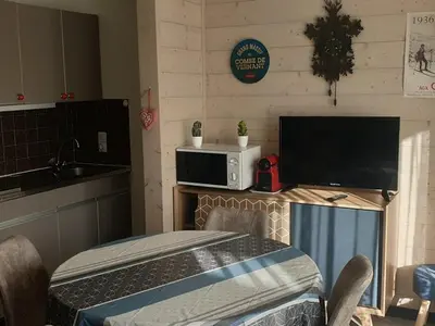 a small kitchen with a table and a microwave at Studio chaleureux, balcon sud, 4 pers., proche centre et pistes - Les Carroz - FR-1-572-218 in Arâches-la-Frasse