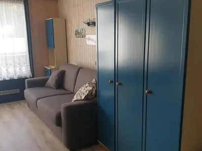 a living room with a couch and a blue cabinet at Studio chaleureux, balcon sud, 4 pers., proche centre et pistes - Les Carroz - FR-1-572-218 in Arâches-la-Frasse