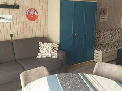 a living room with a couch and a blue cabinet at Studio chaleureux, balcon sud, 4 pers., proche centre et pistes - Les Carroz - FR-1-572-218 in Arâches-la-Frasse