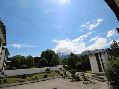 a view of the mountains from the courtyard of a building at Studio chaleureux, balcon sud, 4 pers., proche centre et pistes - Les Carroz - FR-1-572-218 in Arâches-la-Frasse