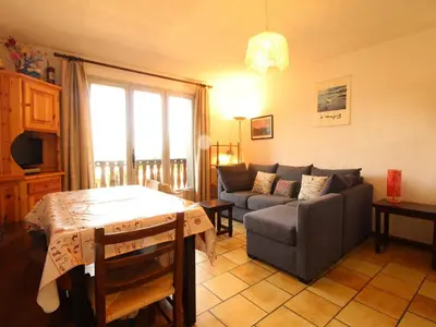 a living room with a couch and a table at Studio 4 pers, rénove, lave-vaisselle, parking, pied des pistes - FR-1-572-197 in Arâches-la-Frasse