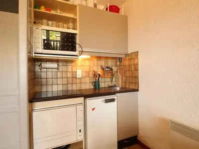 a small kitchen with white cabinets and appliances at Studio 4 pers, rénove, lave-vaisselle, parking, pied des pistes - FR-1-572-197 in Arâches-la-Frasse