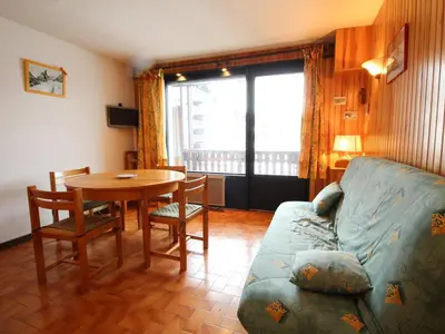 a living room with a couch and a table at Appartement cosy 6 pers, balcon plein sud - à 550m du centre et à 1000m des pistes - FR-1-572-198 in Arâches-la-Frasse