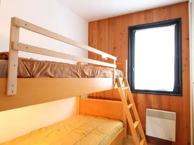 a bunk bed room with two bunk beds and a window at Appartement cosy 6 pers, balcon plein sud - à 550m du centre et à 1000m des pistes - FR-1-572-198 in Arâches-la-Frasse