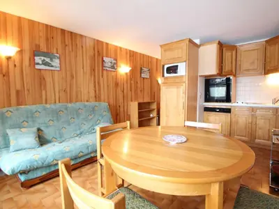 a living room with a table and a couch at Appartement cosy 6 pers, balcon plein sud - à 550m du centre et à 1000m des pistes - FR-1-572-198 in Arâches-la-Frasse