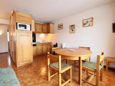 a kitchen and dining room with a table and chairs at Appartement cosy 6 pers, balcon plein sud - à 550m du centre et à 1000m des pistes - FR-1-572-198 in Arâches-la-Frasse