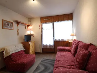 a living room with a red couch and a window at Appartement rénové 2P 4 pers, proche pistes et commerces - FR-1-572-20 in Arâches-la-Frasse