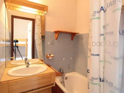 a bathroom with a sink and a tub and a mirror at Studio cosy 4 pers. au pied des pistes avec balcon - Proche centre et commodités - FR-1-572-151 in Arâches-la-Frasse