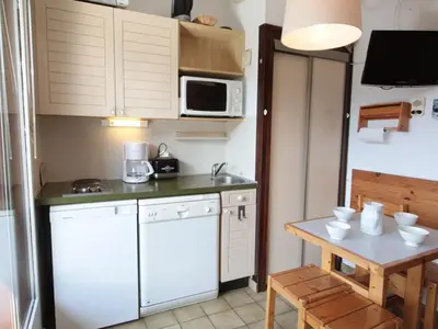 a small kitchen with white appliances and a table at Studio cosy 4 pers. au pied des pistes avec balcon - Proche centre et commodités - FR-1-572-151 in Arâches-la-Frasse