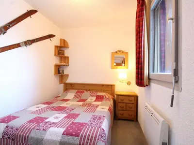 a small bedroom with a bed and a window at 2P tout confort face aux pistes, proche commerces, 6 couchages, balcon S-E, parking, casier à skis - FR-1-572-97 in Arâches-la-Frasse