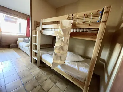 a couple of bunk beds in a room at Studio 4 pers. au pied des pistes, balcon, parking, Wi-Fi, proche commerces - FR-1-572-238 in Arâches-la-Frasse