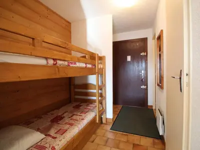 a bedroom with two bunk beds and a hallway at Studio spacieux 4 pers avec garage, lave-vaisselle aux Carroz - FR-1-572-159 in Arâches-la-Frasse