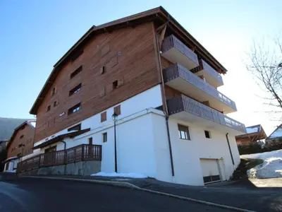 a large white building with a wooden roof at Studio spacieux 4 pers avec garage, lave-vaisselle aux Carroz - FR-1-572-159 in Arâches-la-Frasse