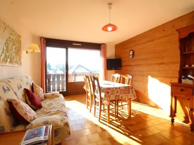 a living room with a table and a couch at Studio spacieux 4 pers avec garage, lave-vaisselle aux Carroz - FR-1-572-159 in Arâches-la-Frasse