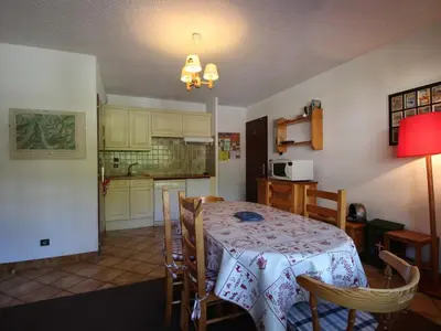 a kitchen and dining room with a table and chairs at 3 pièces pour 6 personnes face aux pistes et commerces, stationnement inclus - FR-1-572-190 in Arâches-la-Frasse
