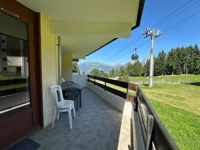 a balcony with a view of some buildings at Bel appartement familial aux pieds des pistes - FR-1-642-73 in Morillon
