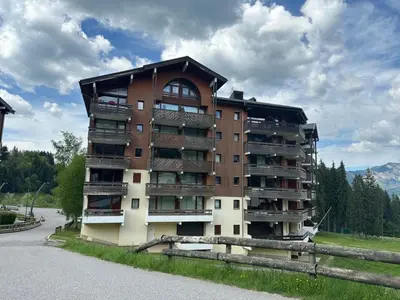 an apartment building with a barn in front of it at Bel appartement familial aux pieds des pistes - FR-1-642-73 in Morillon